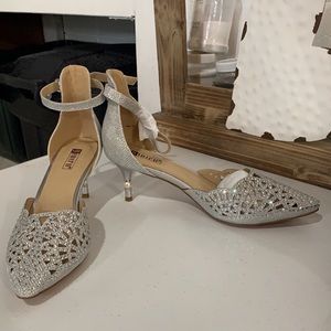 Never worn - silver short heel, approx 2 - 2 1/2 inch heel with ankle strap.